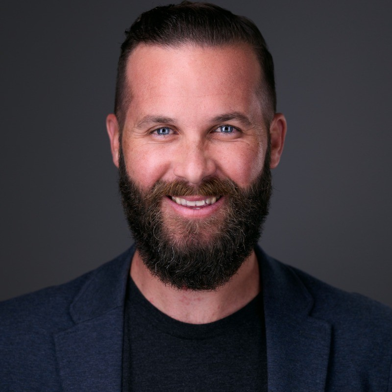 Brett Farmiloe is CHRO & CEO of Featured seen with a bright smile on his face
